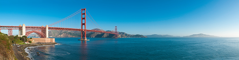 Clear blue California skies over this panoramic vista across San Francisco Bay, the iconic red towers of the Golden Gate Bridge and Fort Point to the Marin Headlands beyond. ProPhoto RGB profile for maximum color fidelity and gamut.