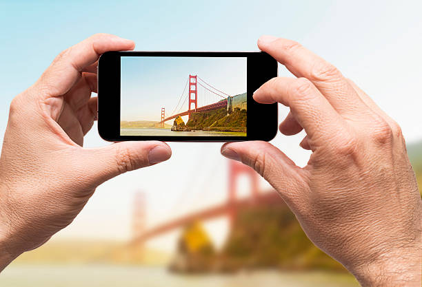 Golden Gate taking picture smart phone stock photo