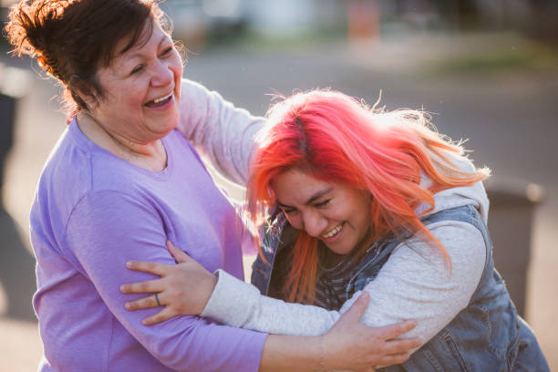 Golden Hour Hugs from Mother to Daughter stock photo