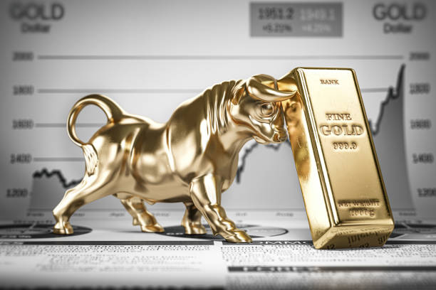 Golden ingot and bull on graph.  Bull market trend in gold. stock photo