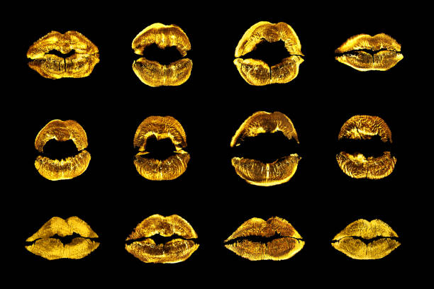 Golden lipstick kiss print set black background isolated close up, yellow sexy lips mark makeup collection, gold female kisses imprint, beauty make up wallpaper, fashion banner, love & passion symbol stock photo