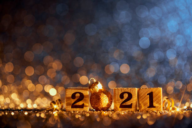 Golden New Year 2021 Christmas Decoration - Blue Party Celebration Wood Cube Golden numbers 2021 and Christmas decorations on glitter and defocused lights. happy new year 2021 stock pictures, royalty-free photos & images