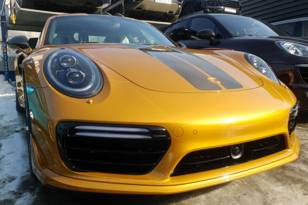 Golden Porsche 911 Turbo s Exclusive series. Limited edition. Number three hundred thirty seven. In the world were produced only 500 cars. Front side view stock photo