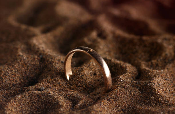 golden ring close-up on the beach sand golden ring close-up on the beach sand divorce beach stock pictures, royalty-free photos & images