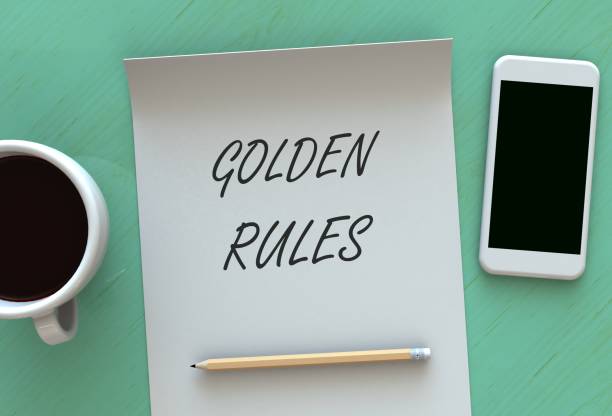 Golden Rules, message on paper, smart phone and coffee on table, 3D rendering stock photo