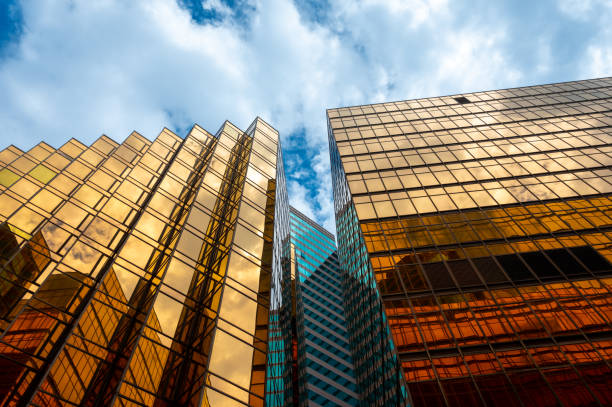 Golden skyscrapper building with blue sky in Hong Kong. Windows glass of modern office  architecture design. Architecture exterior for cityscape background. stock photo
