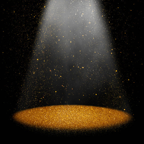 Golden stage Twinkling gold glitter falling on the stage illuminated with one spot light staging light stock pictures, royalty-free photos & images