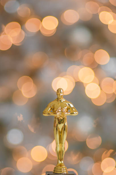 golden statuette of the winner on a beautiful bokeh background golden statuette of the winner on a beautiful bokeh background hunting trophy stock pictures, royalty-free photos & images