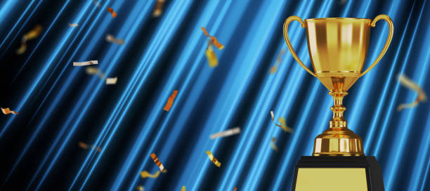 Golden trophy cup on blue background. copy space for text. 3d rendering. stock photo