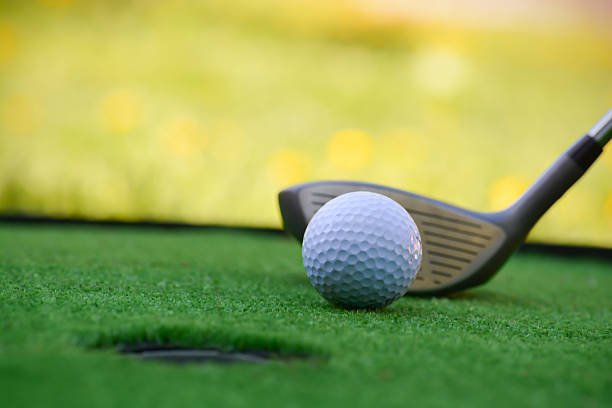 Golf field hole with cross and ball stock photo