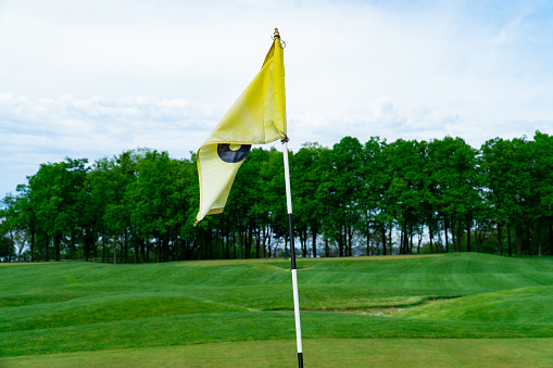 golf flag, in the background of the golf course
