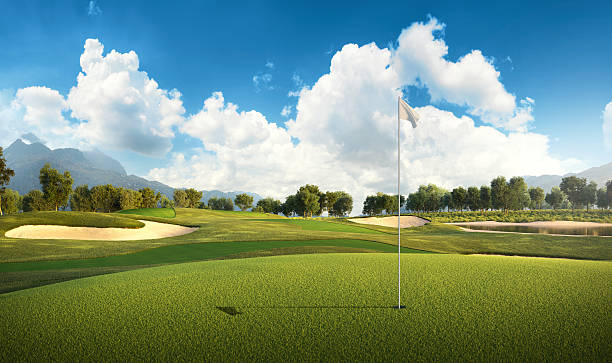 View of the green rolling landscape and bunkers or sand traps at Golf course. The golf field is made in 3D.