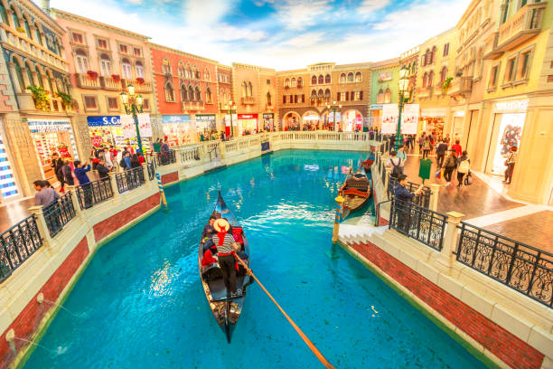 Gondola in The Venetian Casino Macau, China - December 9, 2016: gondolier with tourists during a ride in an authentic gondola down Grand Canals at the Venetian Luxury Hotel and Casino. Inside shopping mall in Cotai Strip. the venetian macao stock pictures, royalty-free photos & images