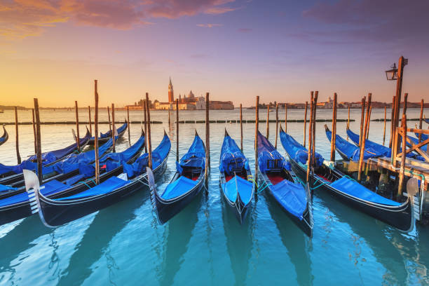 Gondolas in Venice at sunrise stock photo
