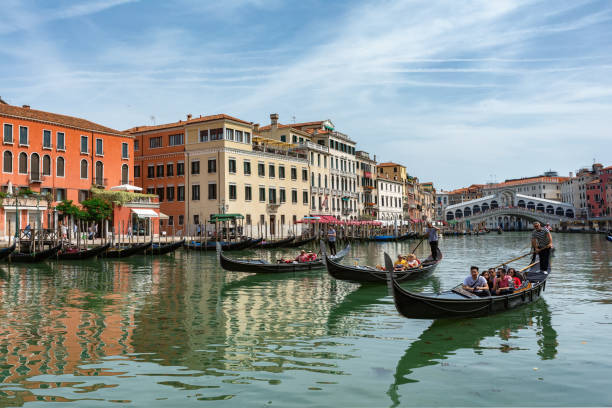 Gondolas near to the Rialto bridge on Grand canal street in Venezia stock photo