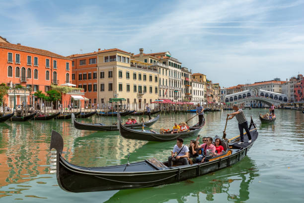Gondolas near to the Rialto bridge on Grand canal street in Venezia stock photo