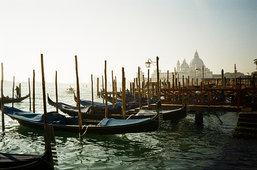 Color film photograph of gondolas docked in the Grand Canal in Venice, Italy.