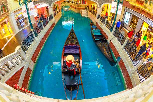 Gondolier at Venetian Macao Macau, China - December 9, 2016: aerial wide view of a gondolier crosses the Grand Canals of Shoppes at the Venetian Luxury Hotel and Casino in Cotai Strip the venetian macao stock pictures, royalty-free photos & images