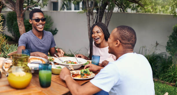 Good food, good people, good times Shot of a happy family having lunch out in the backyard barbecue meal photos stock pictures, royalty-free photos & images