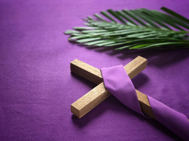 Good Friday, Lent Season and Holy Week concept. A religious cross and palm leaves on purple background. lent stock pictures, royalty-free photos & images