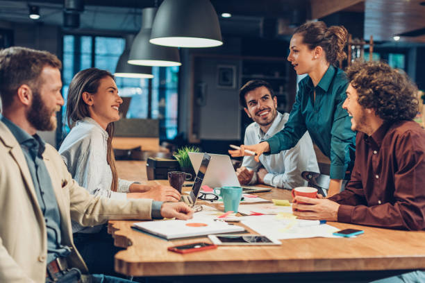 Good leadership and teamwork lead to success Group of people on a business meeting late in the evening strict leader stock pictures, royalty-free photos & images