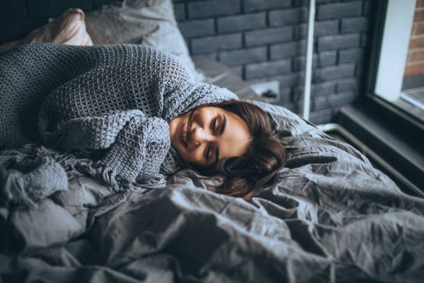 Good morning world Young woman in a bedroom, waking up blanket stock pictures, royalty-free photos & images