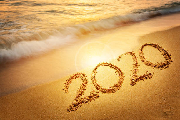Goodbye 2019 Happy New Year 2020 lettering on sunset beach with wave and sea. Handwritten inscription 2019 and 2020 on beautiful golden sand beach. New Years 2020 replace 2019 concept  wave goodbye asian stock pictures, royalty-free photos & images