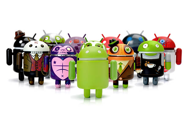 Google Android phone characters group Forest Row, East Sussex, UK - July 30th 2013: Android figure shot in home studio on white. cyborg stock pictures, royalty-free photos & images