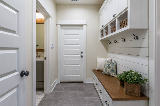 Gorgeous mudroom with white shiplap wall and cabinets Brown wood bench with a touch of classy decor shiplap stock pictures, royalty-free photos & images