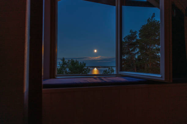 Gorgeous view of sunset trough open window. Sweden. stock photo