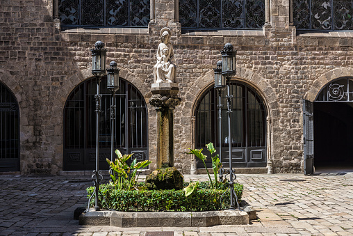 Barcelona, Spain - June 17, 2015: Statue of the Madonna and baby Jesus in the Arquebisbat House, in the heart of Barri Gotic (gothic quarter) 