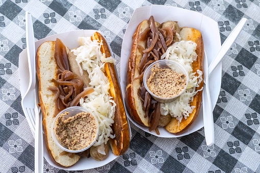 Gourmet hotdog in a pretzel bun with Sauerkraut, Onions and German mustard from above