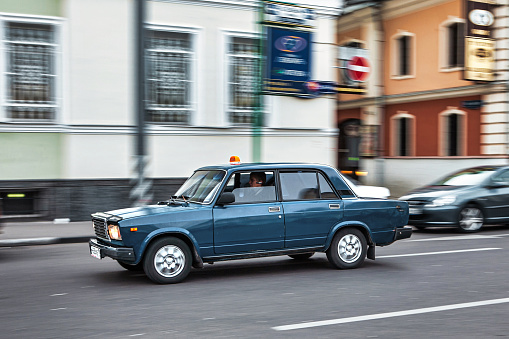 Moscow, Russia - September 11 2010: a state official drives in an government soviet lada car in full motion on the streets downtown