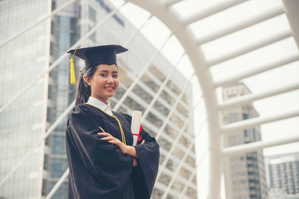 Graduate Student and Success Education in University Concept. Happy Asian student woman graduate diploma and MBA degree in asian college. stock photo