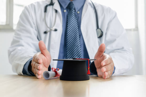 Graduation cap in hand of doctor. Graduation cap in hand of doctor, medical education course degree concept. medical degrees online stock pictures, royalty-free photos & images
