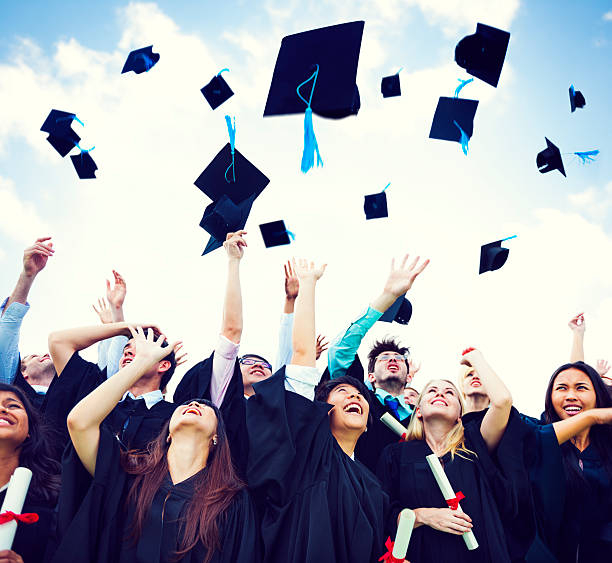 Graduation Caps Thrown in the Air  throwing stock pictures, royalty-free photos & images