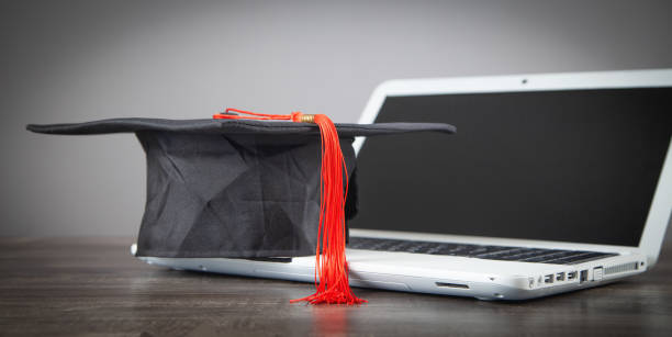 Graduation hat and laptop. Online Education Graduation hat and laptop. Online Education online phd programs stock pictures, royalty-free photos & images