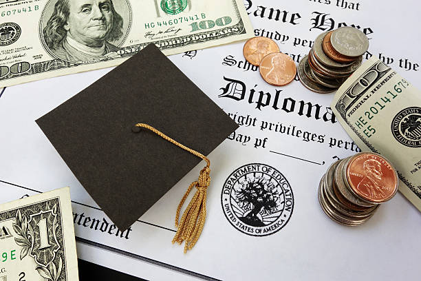 graduation money College or high school diploma with mini mortar board and money student loan stock pictures, royalty-free photos & images
