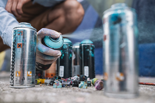 Graffiti Artist's Hand Reaching For Spray Bottle