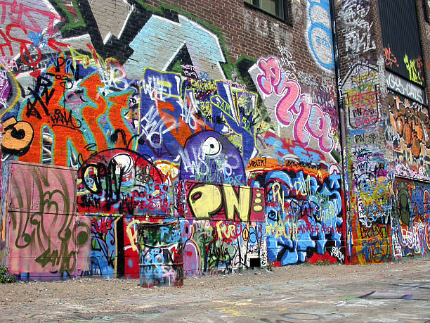 Graffiti wall with many colored murals stock photo