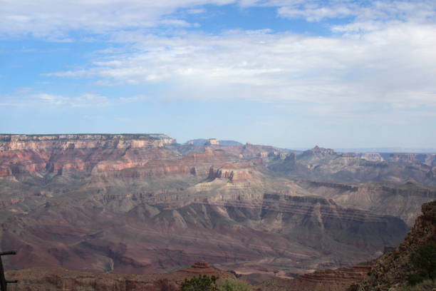 Grand Canyon Landscape Under Vibrant Blue Sky with White Clouds stock photo