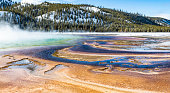 Grand Prismatic Spring at Midway Geyser Basin in the winter with the very colorful thermophilic organisms at the edges. Yellowstone National Park.