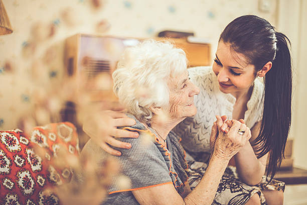 Granddaughter embracing her happy grandmother at home  white hair young woman stock pictures, royalty-free photos & images
