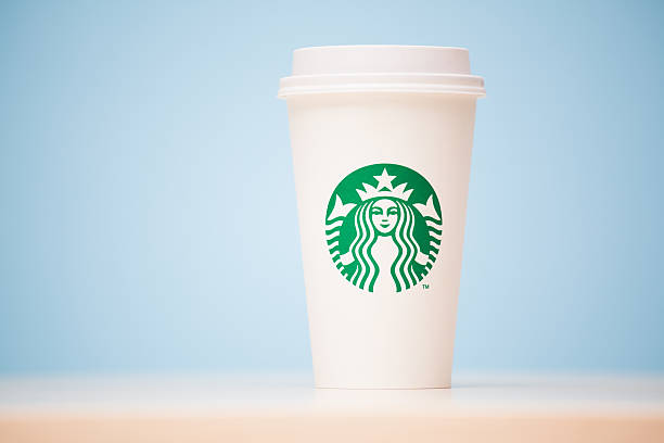Grande Starbucks to go cup on table stock photo