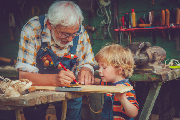 Grandfather and grandson in workshop Grandfather and his little grandson  basement photos stock pictures, royalty-free photos & images