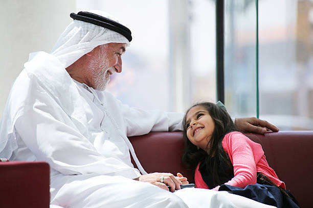 Grandfather with his granddaughter Grandfather with his granddaughter old arab man stock pictures, royalty-free photos & images