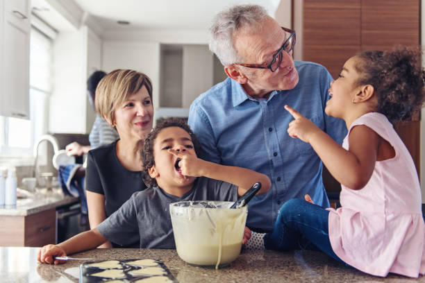 Grandparents cooking with kids Grandparents making cupcake with kids multi generation family stock pictures, royalty-free photos & images