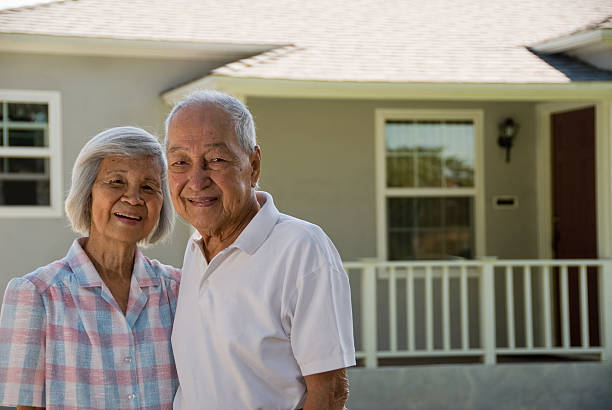Grandparents - People Series Grandma and Grandpa in front of house smiling at the camera. in front of stock pictures, royalty-free photos & images