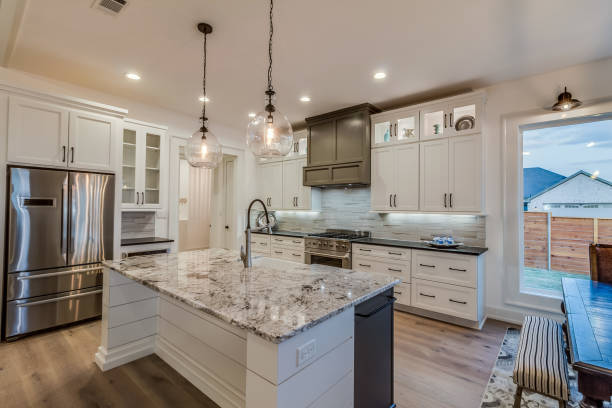 Granite countertops and two pendant lights above island stock photo