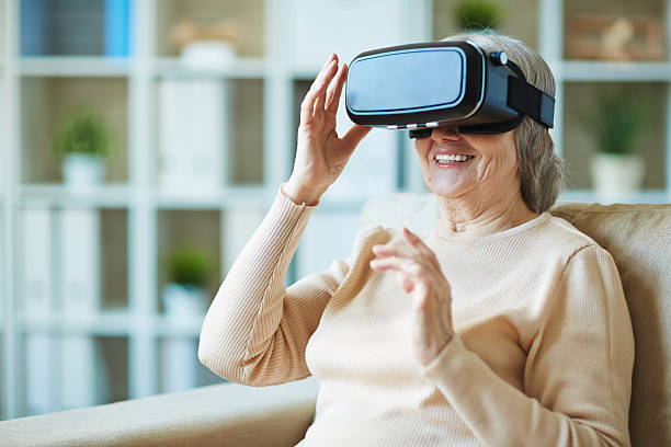 senior women playing with virtual reality googles laughing